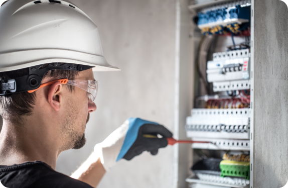 man-electrical-technician-working-switchboard-with-fuses-installation-connection-electrical-equipment